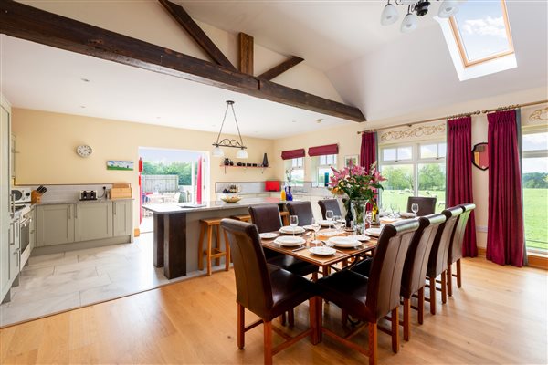 dining table for 12 by the kitchen with views out of the windows